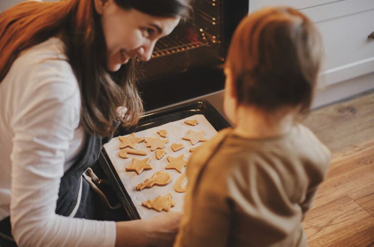 A mom and her son baking cookies. A mom and her son baking cookies.