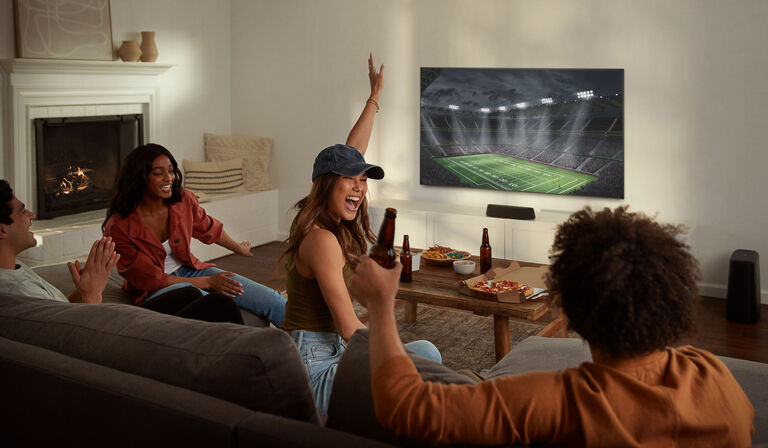 A group of people watching a football game. A group of people watching a football game.