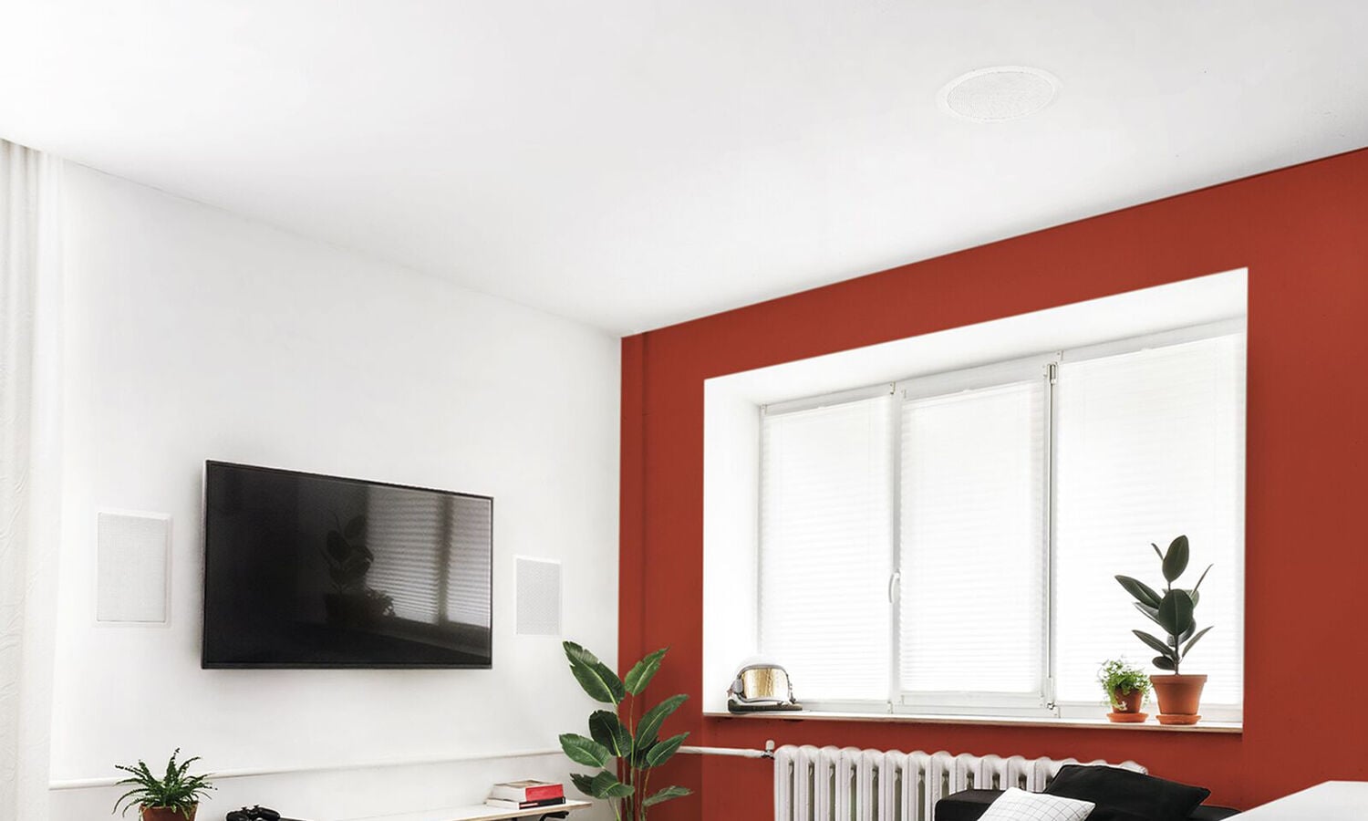 Speakers installed in the wall next to a tv
