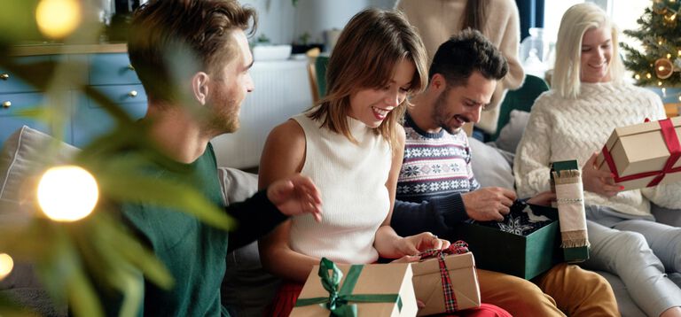 A group of people opening gifts. A group of people opening gifts.