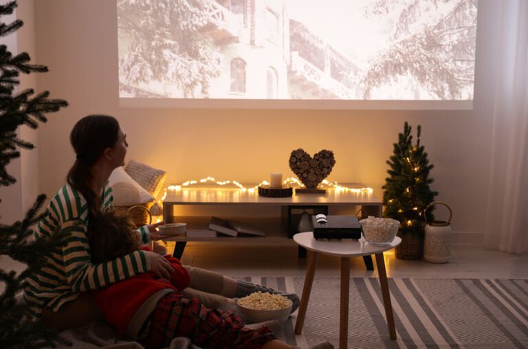 A woman watching a movie from a projector. A woman watching a movie from a projector.