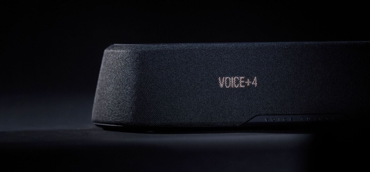 Woman watching tv with a compact sound bar.