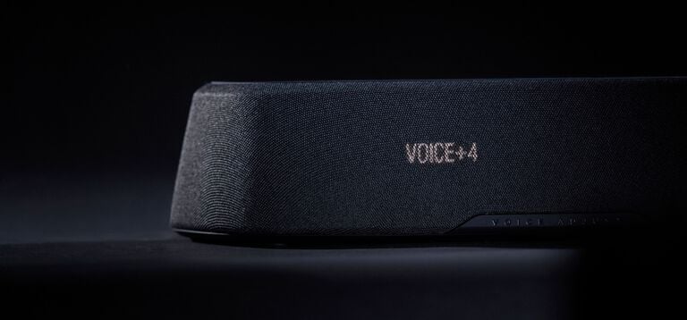 Woman watching tv with a compact sound bar.
