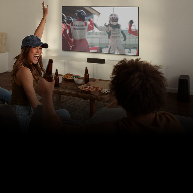 Woman excited watching sports on tv Woman excited watching sports on tv