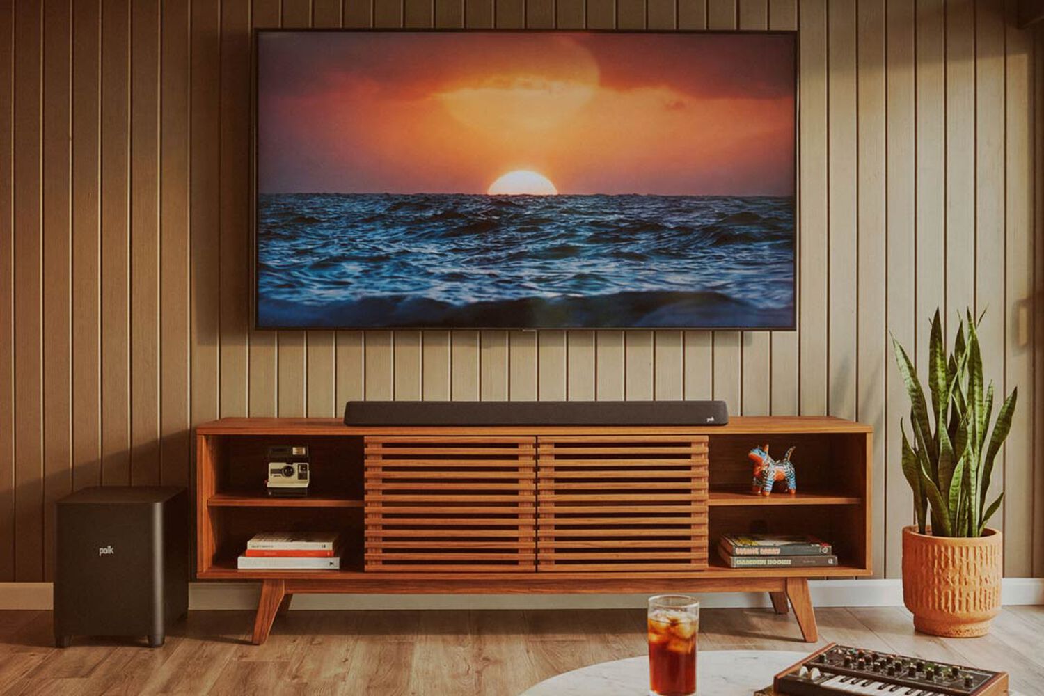 A soundbar and subwoofer under a tv