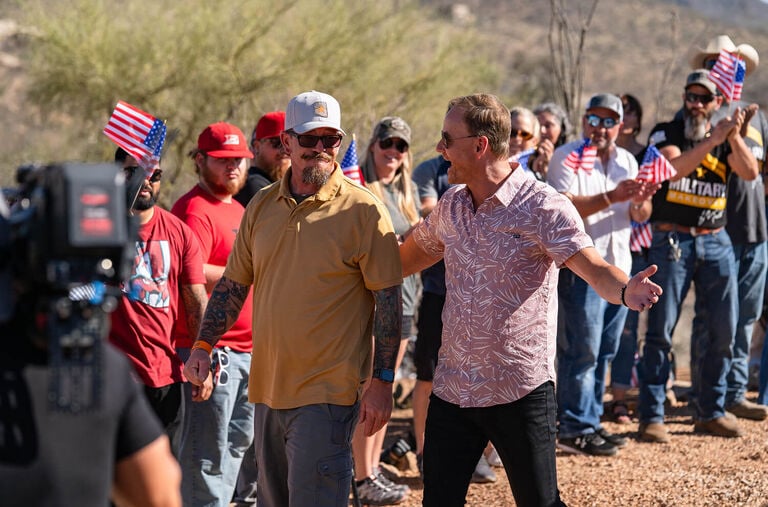 Two men high fiving, watching a football game. Two men high fiving, watching a football game.