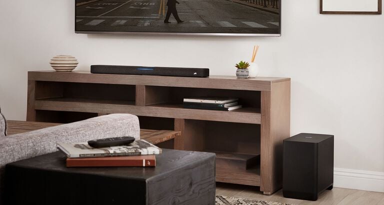A furnished room with a mounted TV and soundbar.