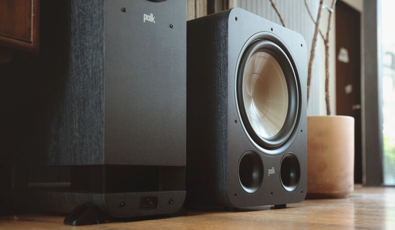A couple dancing with music from a sound bar.